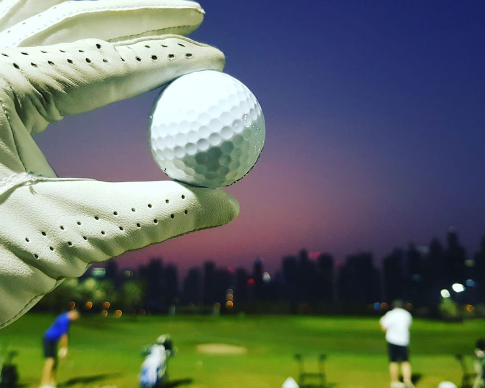 Luxury championship golf course at golden hour with manicured fairways and palm trees